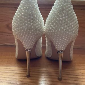 Women’s white pearl coated heel shoes.